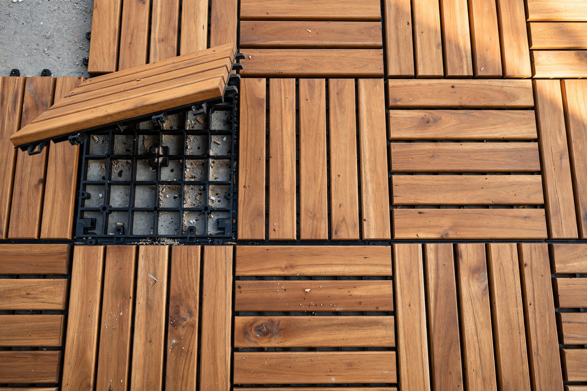 Interlocking acacia deck tiles over concrete patio floor