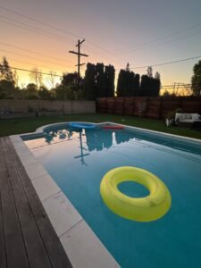 Cheap backyard pool idea with stock tank pool and string lights looking expensive
