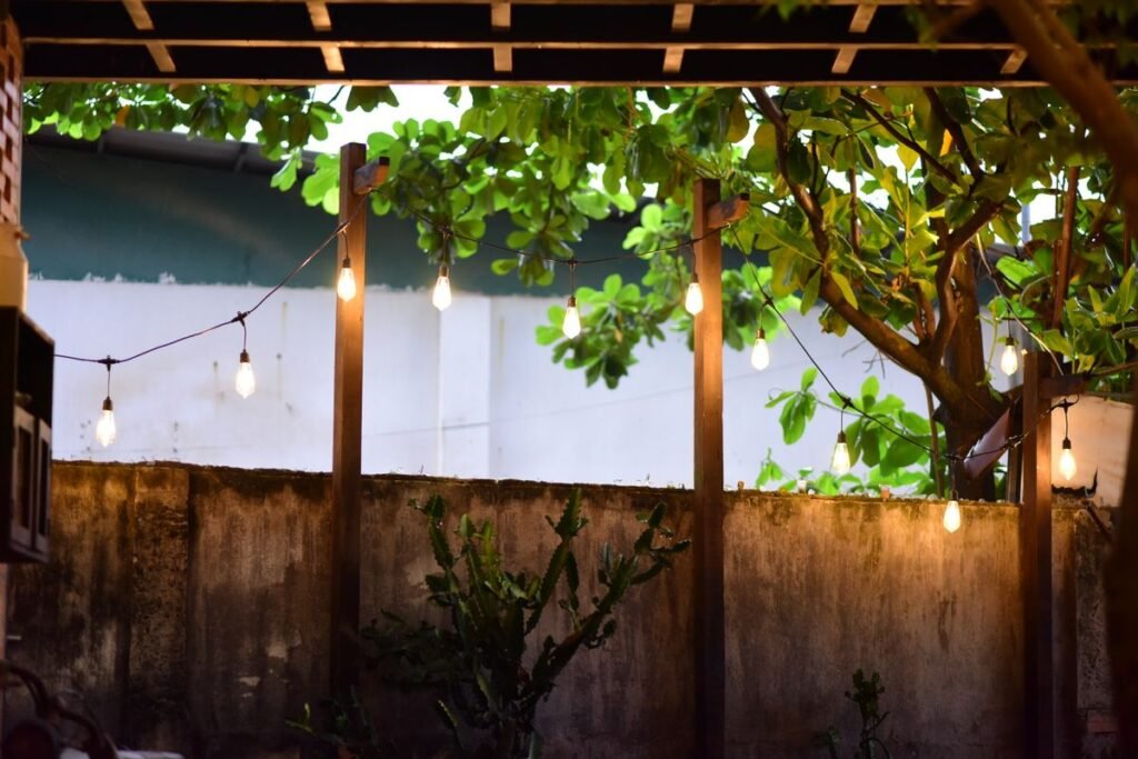 Projector screen without drilling — cozy patio with string lights on wooden posts