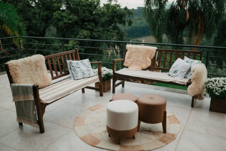 Cozy outdoor living space ideas — wooden benches with sheepskin throws and cushions on a patio