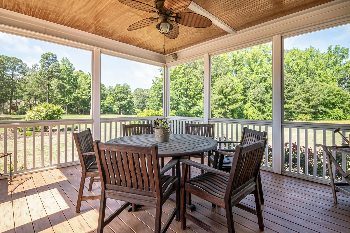 Outdoor dining room under gable roof patio with ceiling fan