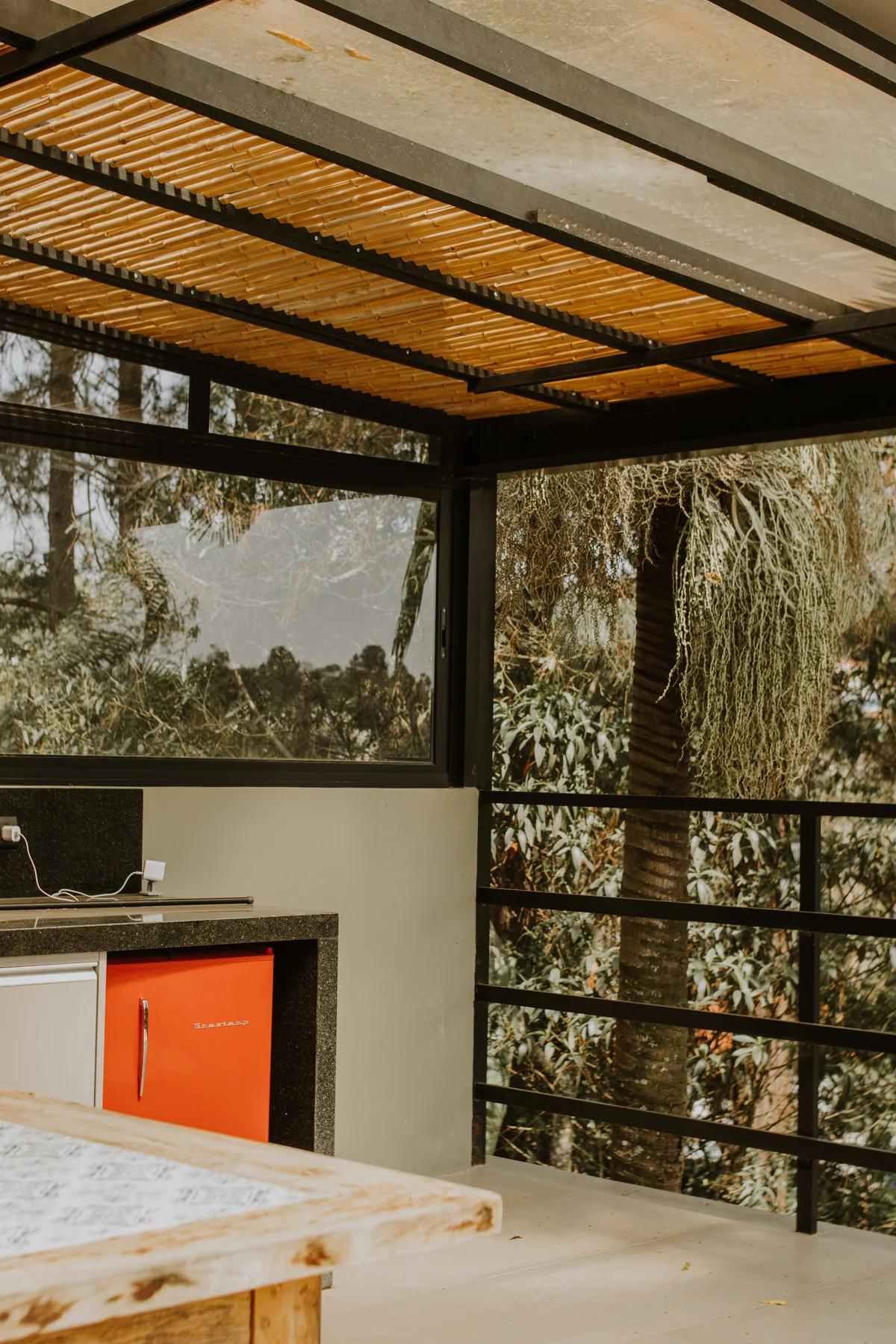 Outdoor kitchen under gable roof patio cover with grill station