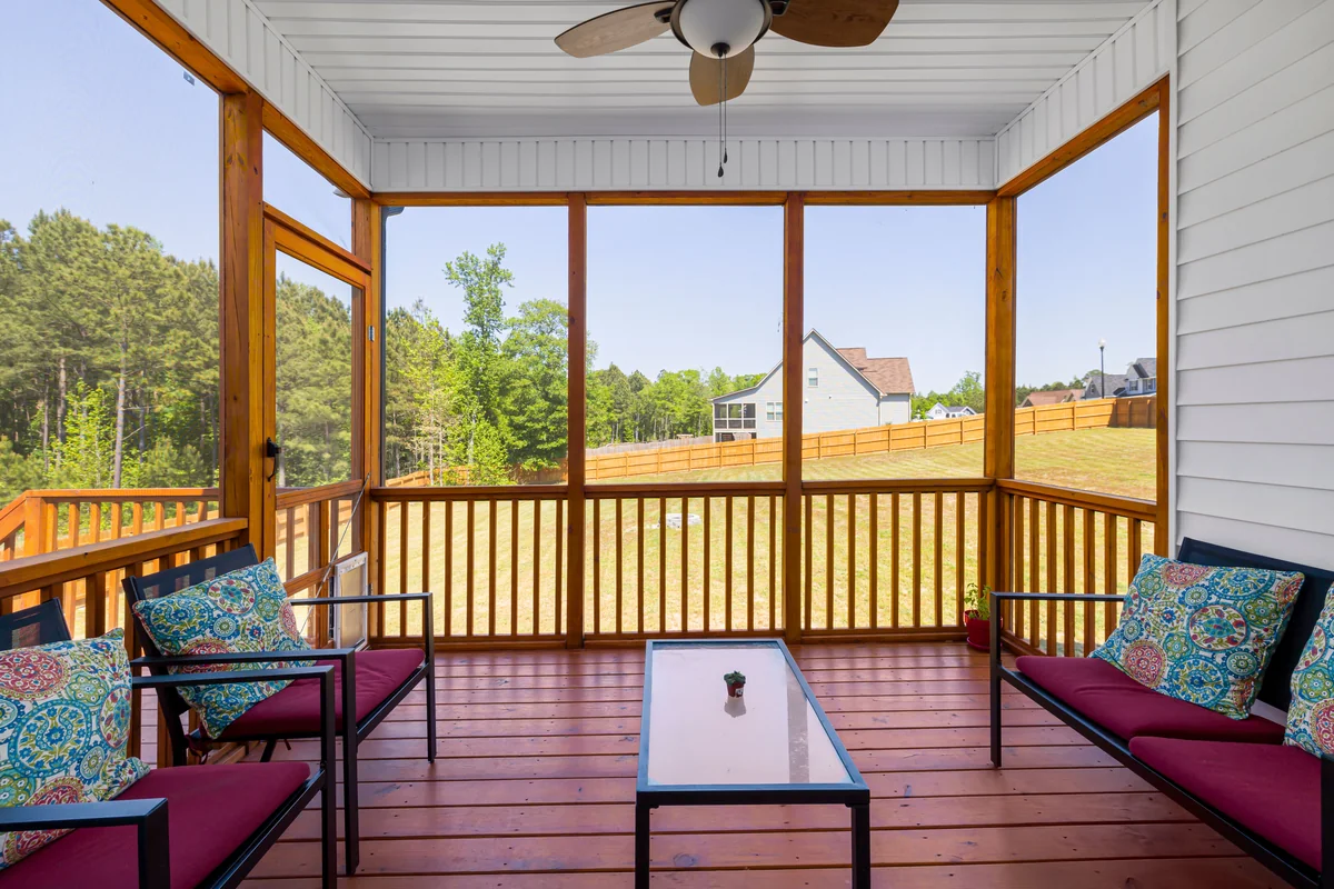 Screened-in gable porch with wooden framing and ceiling fan