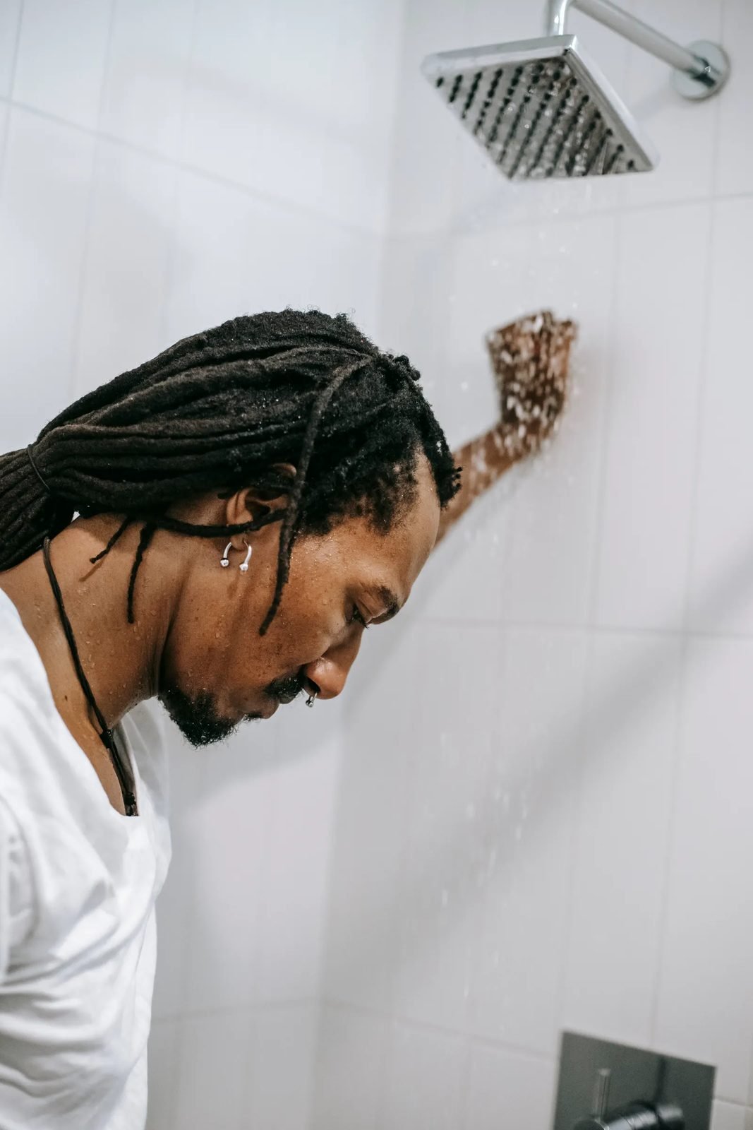Man showering under a rainfall shower head
