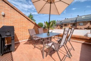 Patio umbrella on a sturdy base over an outdoor table set